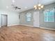 Bright living room with wood-look tile floors and ceiling fan at 1480 Battle St, Oviedo, FL 32765