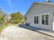 Gravel driveway and side yard with exterior door at 1480 Battle St, Oviedo, FL 32765