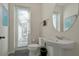 Small bathroom with toilet and sink at 1552 Carey Palm Cir, Kissimmee, FL 34747