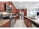 Modern kitchen with stainless steel appliances and wood cabinets at 1552 Carey Palm Cir, Kissimmee, FL 34747