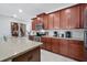 Modern kitchen with stainless steel appliances and wood cabinets at 1552 Carey Palm Cir, Kissimmee, FL 34747