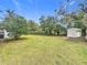 Fenced backyard with shed and mature trees at 1630 Smithfield E Cir, Lakeland, FL 33801