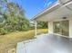 Backyard with patio and sliding glass door access at 1630 Smithfield E Cir, Lakeland, FL 33801