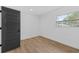 Simple bedroom with gray door and wood-look floors at 1638 Frances Dr, Apopka, FL 32703