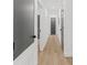 Long hallway with light walls and gray doors at 1638 Frances Dr, Apopka, FL 32703