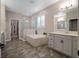 Spa-like bathroom with soaking tub, walk-in shower, and double vanity at 17608 Sailfin Dr, Orlando, FL 32820