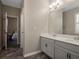 Modern bathroom with double vanity and view to bedroom at 17608 Sailfin Dr, Orlando, FL 32820