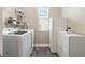 Functional laundry room with washer, dryer, and shelving at 17608 Sailfin Dr, Orlando, FL 32820