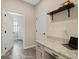 Bright laundry room with built-in desk and access to adjacent rooms at 17608 Sailfin Dr, Orlando, FL 32820