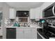 Modern kitchen with white cabinets and tile backsplash at 1783 Flores Ct, Orlando, FL 32811