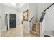 Bright entryway with tiled floors and staircase at 2058 Newtown Rd, Groveland, FL 34736