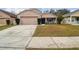 Two-story house with attached garage and landscaping at 2058 Newtown Rd, Groveland, FL 34736