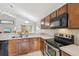 Modern kitchen with stainless steel appliances and wood cabinets at 2058 Newtown Rd, Groveland, FL 34736