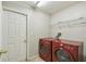 Bright laundry room with washer, dryer, and ample shelving at 2058 Newtown Rd, Groveland, FL 34736