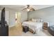 Comfortable main bedroom with ceiling fan and access to the bathroom at 2058 Newtown Rd, Groveland, FL 34736