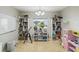 Bright playroom features built-in shelving, a whiteboard, and a telescope at 2058 Newtown Rd, Groveland, FL 34736