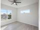 Bedroom with large window and ceiling fan at 208 Snowy Orchid Way, Lake Alfred, FL 33850