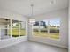 Spacious dining area with large windows and modern light fixture at 208 Snowy Orchid Way, Lake Alfred, FL 33850