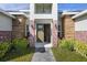 Inviting entryway with a double door and brick columns at 208 Snowy Orchid Way, Lake Alfred, FL 33850