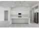 White kitchen with an island and pendant lighting at 208 Snowy Orchid Way, Lake Alfred, FL 33850