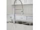 Close-up of a modern kitchen faucet with a high-arc design and double sink at 208 Snowy Orchid Way, Lake Alfred, FL 33850