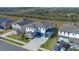 Aerial view of two-story house with gray roof and teal garage doors at 2338 Gold Dust Dr, Minneola, FL 34715