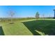 Large backyard with grassy area and distant landscape view at 2338 Gold Dust Dr, Minneola, FL 34715