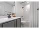 Clean bathroom with gray vanity, white tile, and a bathtub at 2338 Gold Dust Dr, Minneola, FL 34715