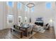 Bright dining area with a long wooden table and bench seating at 2338 Gold Dust Dr, Minneola, FL 34715