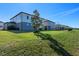 Two story home with backyard, grass, and distant view at 2338 Gold Dust Dr, Minneola, FL 34715