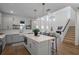 Modern kitchen with white cabinets, quartz countertops, and gold hardware at 2338 Gold Dust Dr, Minneola, FL 34715