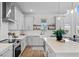 Modern kitchen with white cabinets, quartz countertops, and a farmhouse sink at 2338 Gold Dust Dr, Minneola, FL 34715