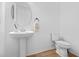 Clean powder room with pedestal sink and toilet at 2338 Gold Dust Dr, Minneola, FL 34715