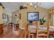 Open concept dining room with hardwood floors, offering views of the living room at 2368 Monaco Cove Cir, Orlando, FL 32825