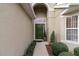 Front entry with green door, pathway, and potted plants at 2368 Monaco Cove Cir, Orlando, FL 32825