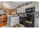 Modern kitchen with granite countertops and black appliances at 2368 Monaco Cove Cir, Orlando, FL 32825