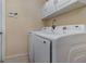 Laundry room with Samsung washer and dryer, and overhead cabinets at 2368 Monaco Cove Cir, Orlando, FL 32825