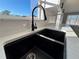 Modern kitchen sink with a black matte finish and gooseneck faucet at 2413 Rock Ct, Poinciana, FL 34759