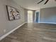 Open living area with gray walls, wood-look flooring, and large window at 2413 Rock Ct, Poinciana, FL 34759