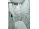 Large walk-in shower with marble tile and rainfall shower head at 2413 Rock Ct, Poinciana, FL 34759