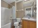 Bathroom with tub shower combo and wood vanity at 2661 Emerald Island Blvd, Kissimmee, FL 34747