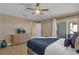 Bedroom with dresser, TV, and access to another room at 2661 Emerald Island Blvd, Kissimmee, FL 34747