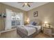 Bedroom with a queen bed and large window at 2661 Emerald Island Blvd, Kissimmee, FL 34747