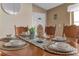 Close-up view of a round wooden dining table setting at 2661 Emerald Island Blvd, Kissimmee, FL 34747