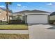 Single-story house with attached garage and well-maintained lawn at 2661 Emerald Island Blvd, Kissimmee, FL 34747