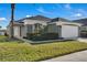 One-story home with attached garage and manicured lawn at 2661 Emerald Island Blvd, Kissimmee, FL 34747