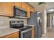 Kitchen features stainless steel appliances and light wood cabinets at 2661 Emerald Island Blvd, Kissimmee, FL 34747