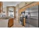 Stainless steel appliances and light wood cabinets in this modern kitchen at 2661 Emerald Island Blvd, Kissimmee, FL 34747