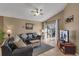 Living room with leather couches, TV, and sliding doors to patio at 2661 Emerald Island Blvd, Kissimmee, FL 34747