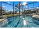 Inviting screened pool and spa with waterfall feature at 2661 Emerald Island Blvd, Kissimmee, FL 34747